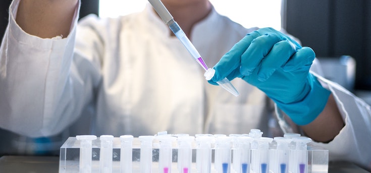 Photograph of a female scientist using a pipette